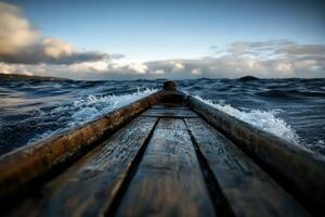Waves crashing against a wooden boat at sunset on a tranquil lake photo