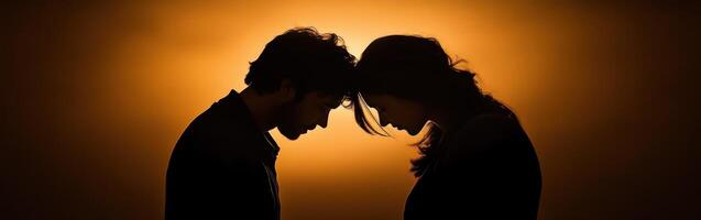 Couple sharing an intimate moment against a warm glowing background photo
