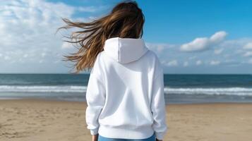 Woman with long hair enjoys a peaceful moment by the ocean photo