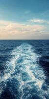 Calm ocean waves under a clear sky during sunset photo
