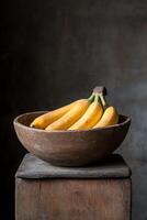 Freshly harvested bananas in a rustic wooden bowl on a table photo