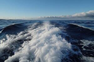 Waves created by a boat cutting through still ocean waters photo