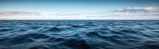 Calm ocean waves under a clear sky at twilight photo