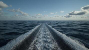 Waves created by a boat navigating through the ocean at sunset photo