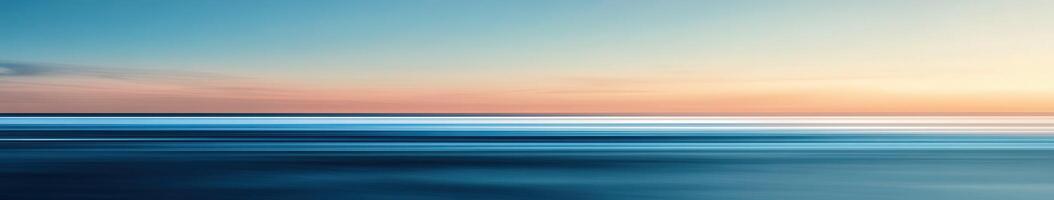 Tranquil sunset over the calm ocean waters at twilight photo