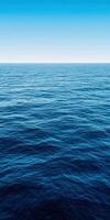 Calm blue ocean waves under a clear sky during the early morning hours photo