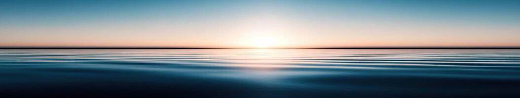 Calm ocean waves under a serene sunrise in early morning light photo
