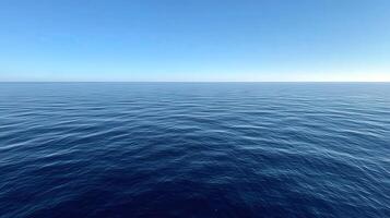 Serene surface of the ocean under clear blue sky during daytime photo