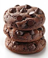 Soft and chewy chocolate chip cookies stacked on a white surface photo