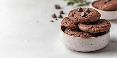 Freshly baked chocolate chip cookies in a bowl on a bright kitchen counter photo