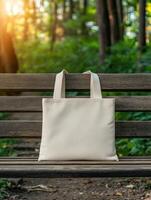 Soft fabric tote bag resting on a wooden bench in a serene park photo
