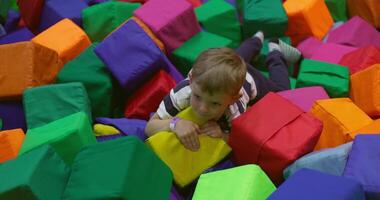 Child playing in colorful foam blocks video