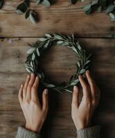 Creating a simple greenery wreath on a rustic wooden table photo