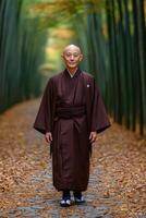 Serene monk walking through a bamboo forest path during autumn photo