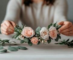 Crafting a beautiful floral headband with roses and greenery indoors photo