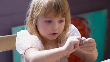 Girl playfully explores shapes using small objects at home video