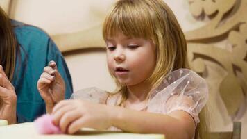 Girl creating colorful crafts with hands in a playful environment video