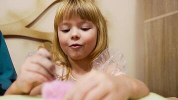 Girl enjoys crafting activity with colorful materials at home video