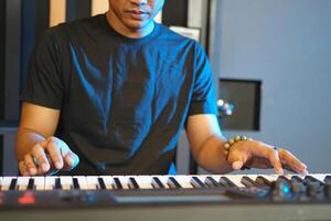 Musician playing music keyboard, Close up of man's hands playing piano photo