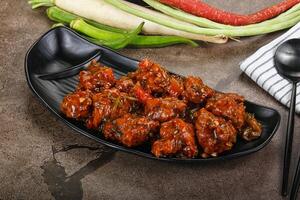 Manchurian chicken with sauce and spices photo