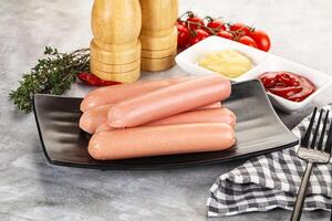 Boiled sausages with ketchup and mustard photo