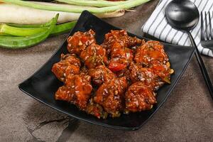 Manchurian chicken with sauce and spices photo