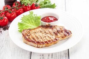 Grilled pork steak with ketchup photo