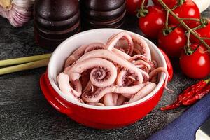 Delicous marinated squid tentacles in the bowl photo