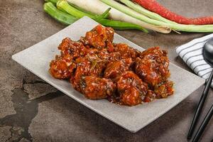 Manchurian chicken with sauce and spices photo