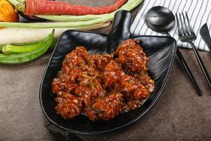 Manchurian chicken with sauce and spices photo