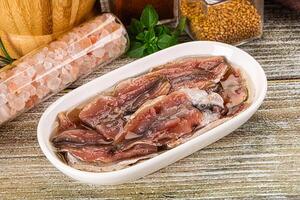 Canned anchovy with oil in the bowl photo