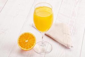 Sweet fresh orange juice in the glass photo