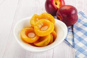 Canned peaches with sweet syrope photo