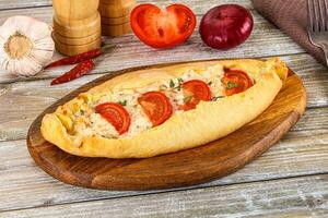 Turkish Pide with cheese and tomato photo