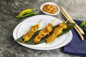 Thai meat skewer Satay with sauce photo