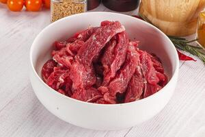 Raw beef meat - sliced strips photo