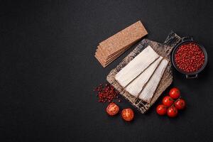 Rectangular whole grain crisp bread with cream cheese photo