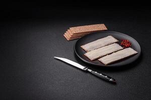 Rectangular whole grain crisp bread with cream cheese photo