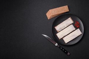 Rectangular whole grain crisp bread with cream cheese photo