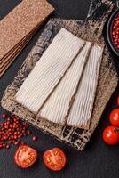 Rectangular whole grain crisp bread with cream cheese photo