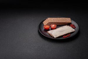 Rectangular whole grain crisp bread with cream cheese photo