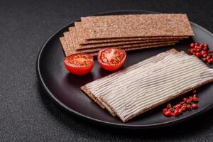 Rectangular whole grain crisp bread with cream cheese photo