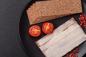 Rectangular whole grain crisp bread with cream cheese photo