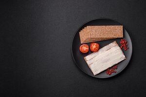 Rectangular whole grain crisp bread with cream cheese photo