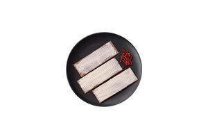 Rectangular whole grain crisp bread with cream cheese photo