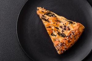 Pieces of quiche with salmon, spinach or broccoli, salt and spices photo