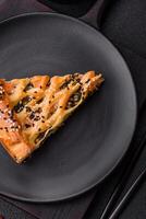 Pieces of quiche with salmon, spinach or broccoli, salt and spices photo