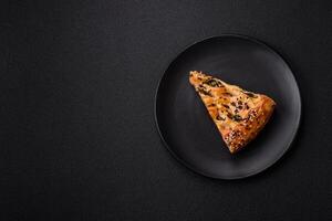 Pieces of quiche with salmon, spinach or broccoli, salt and spices photo