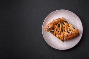 Pieces of quiche with salmon, spinach or broccoli, salt and spices photo