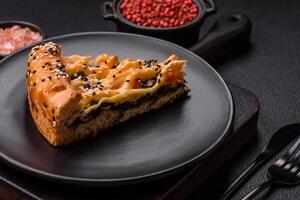Pieces of quiche with salmon, spinach or broccoli, salt and spices photo
